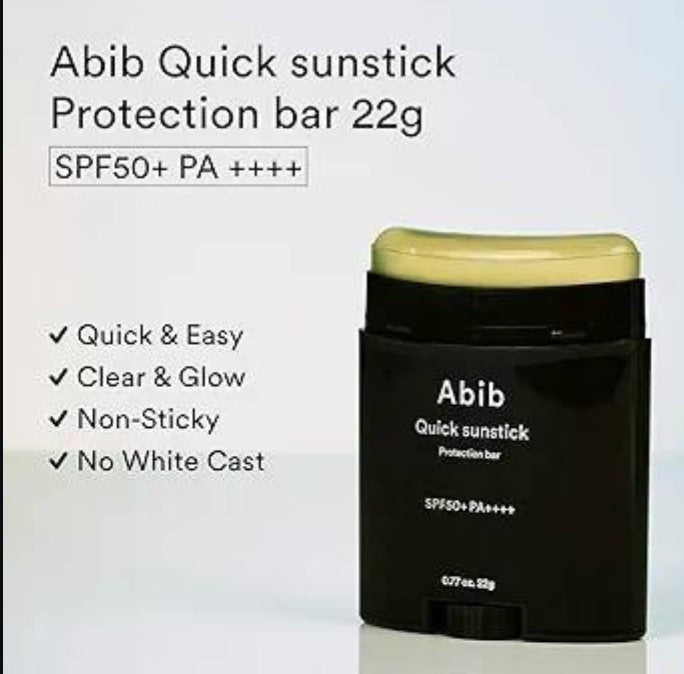 Abib Quick sunstick Protection bar 22g with black packaging and yellow top on a light gray background

