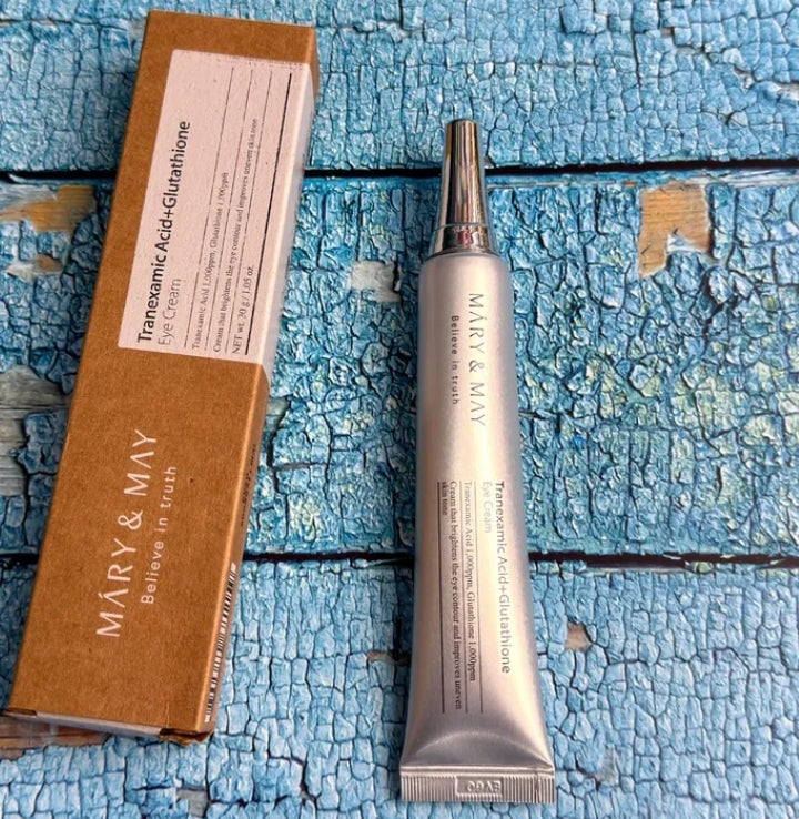 Skincare serum and packaging on a textured blue surface