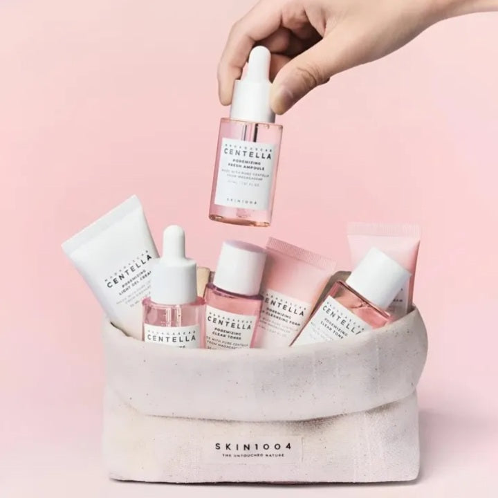 Collection of skincare products with a pink background