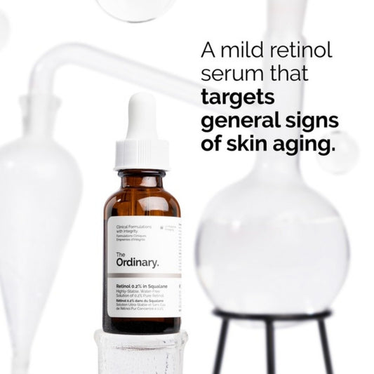 Brown bottle with white label on a white background, featuring text about a mild retinol serum.

